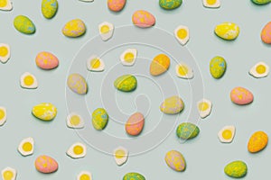 Lovely Easter minimal concept. Optimistic flat lay pattern arrangements made of colorful painted egg and fried eggs with green