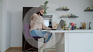 Lovely female with congenital disability and limb prosthesis relaxing in kitchen