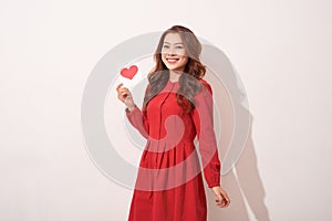 Lovely female with red heart isolated on gray background, celebration of Valentine day, romantic feelings, harmony and love