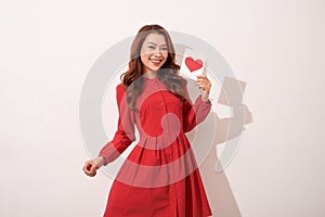 Lovely female with red heart isolated on gray background, celebration of Valentine day, romantic feelings, harmony and love