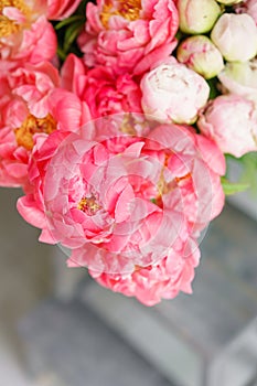 Lovely flowers in glass vase. Beautiful bouquet of peonies sort of coral charm. Floral composition, scene, daylight. Wallpaper. Ve