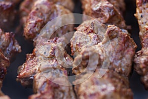 Lovely fresh pieces of smoked meat shish kebab fried on charcoal grill.