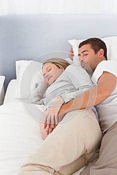 Lovely future parents sleeping in the bedroom