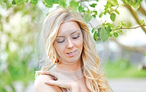 Lovely gentle woman in spring floral garden