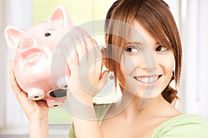 Lovely girl with big piggy bank