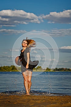 Lovely girl coming out of the water. Splash.