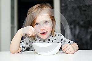 Lovely girl eating soup