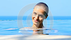 Lovely girl in exotic swimming pool