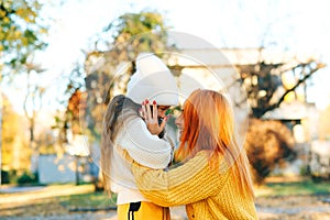 Lovely girl with her mom hugging on autumn walk. Autumn holidays, lifestyle