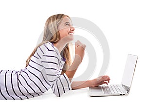 Lovely girl laying on the floor using laptop and celebrating victory,isolated