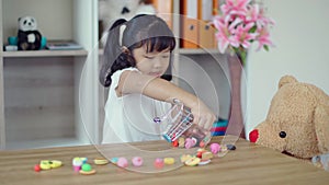 Lovely girl playing with teddy bear in living room