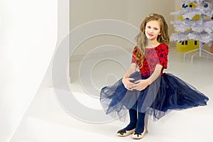 Lovely Girl Posing in Front of Decorated White Christmas Tree.