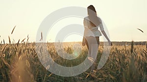 Lovely girl running across the field.