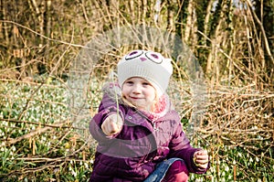 Girl and blossoming white snowdrop photo