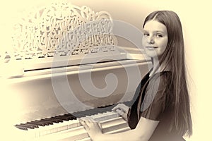 Lovely girl sitting at piano