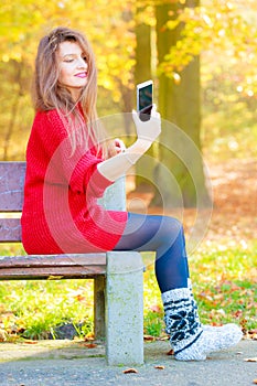 Lovely girl with smartphone taking selfie photo