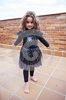 Lovely girl with spider web on face with widened arms