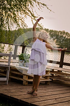 Lovely girl standing at the pond enjoying the moment