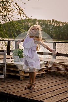 Lovely girl standing at the pond enjoying the moment