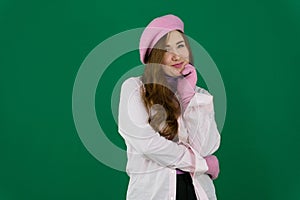 Lovely girl wearing pink french hat. young girl woman with a pink beret on her head France fashion on a green background