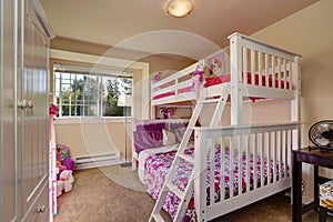 Lovely girls bedroom with bunk bed and carpet floor. photo
