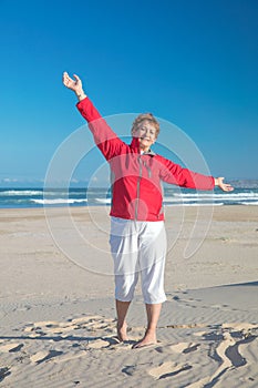 Lovely granny enjoys the freedom of a beach photo