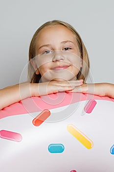 Lovely happy child girl with inflatable ring swimming float closeup. Summer, vacation and leisure activity concept