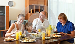 Lovely happy multigeneration family having healthy dinner