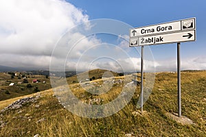 Lovely hilly landscape on a touristic road through Durmitor National Park in the Dinaric Alps with signposts to the villages `Crna photo