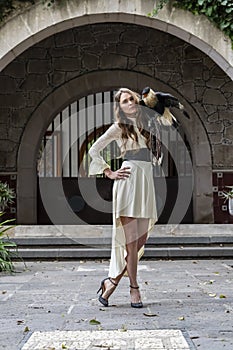 A Lovely Hispanic Brunette Model Poses Outdoors With A Caracara Bird At A Hacienda
