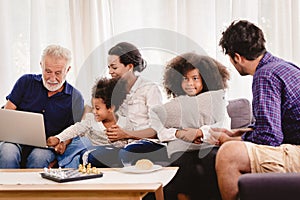 Lovely home happy family living together in living room father mother and grandfather playing with daughter mix race