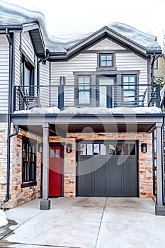 Lovely home with red front door and attached garage with gray glass paned door
