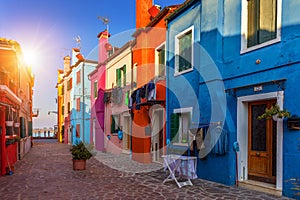 Lovely house facade and colorful walls in Burano, Venice. Burano island canal, colorful houses and boats, Venice landmark, Italy.