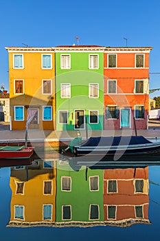 Lovely house facade and colorful walls in Burano, Venice. Burano island canal, colorful houses and boats, Venice landmark, Italy.