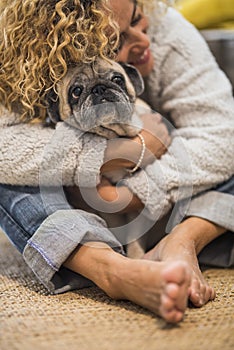 Lovely hug human and animal for pet therapy or domestic dog love and kind woman at home - real scene adult lady and old domestic