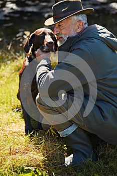 Lovely hunter man hug his dog