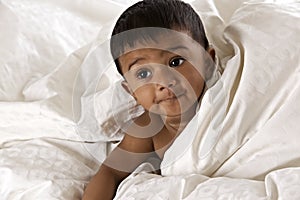 Lovely Indian baby lying on blanket