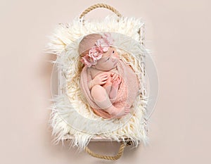 Lovely infant in a flowery hairband, topview