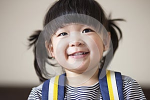 Lovely and innocent asian kid smiled happily