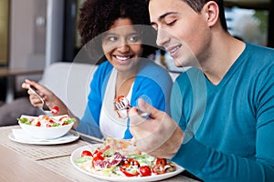 Lovely interracial couple having lunch