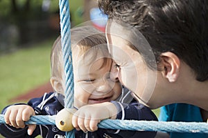 Lovely kid and mother on playground