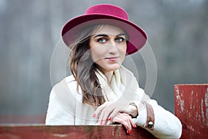 Lovely lady woman in a red hat outdoors