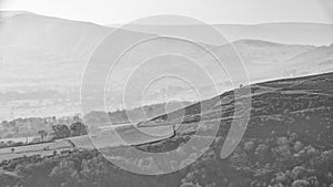 Lovely landscape image of the Peak District in England on a hazy Winter day viewed from the lower slopes of Bamford Edge in black