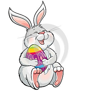 Lovely laughing bunny holding painted easter egg