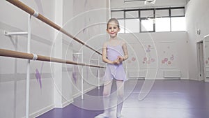 Lovely little ballerina practicing her dancing at ballet school