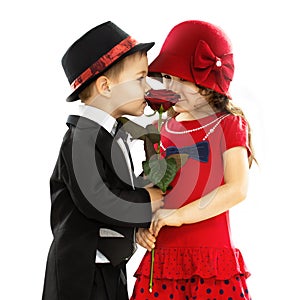 Lovely little boy giving a rose to girl