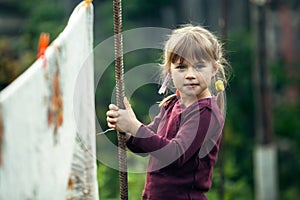 Lovely little girl with clothespin, outdoor.