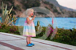 Lovely little girl eating ice cream on the beach