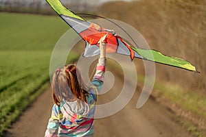 Lovely little girl flying kite