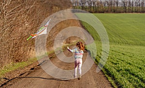 Lovely little girl flying kite